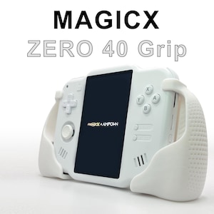 May include: A white handheld gaming device with a black screen and white grip handles. The device has a directional pad, buttons, and the text "MAGICX ZERO 40 Grip". The screen displays the logo "MAGICX + AMPOWN".