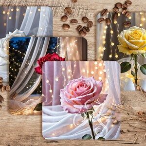 May include: Four square coasters with a white sheer fabric background and a single rose in each. The roses are white, red, yellow, and pink. The background is decorated with white fairy lights.