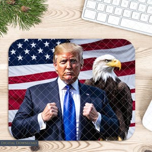 May include: A mouse pad featuring a portrait of a man in a dark suit and blue tie, standing in front of an American flag with a bald eagle to the right.