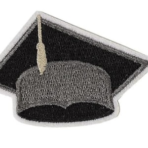 May include: Embroidered graduation cap patch. The patch features a black mortarboard with a gray cap and a gold tassel. The edges are outlined in white. This patch is ideal for celebrating academic achievements and milestones.