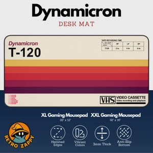 May include: A rectangular desk mat with a retro design. The mat features a color gradient of yellow, orange, and red stripes. The text "Dynamicron" and "Desk Mat" are at the top. The mat is available in XL and XXL sizes, measuring 22" x 12" and 32" x 16".