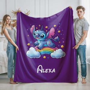 May include: Purple fleece blanket with a blue Stitch character riding a rainbow with stars and the name "ALEXA" printed on the bottom.