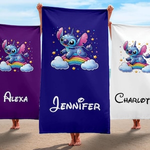 May include: Three beach towels with a blue Stitch character riding a rainbow. The towels are purple, blue, and white. The names Alexa, Jennifer, and Charlotte are printed on the towels.
