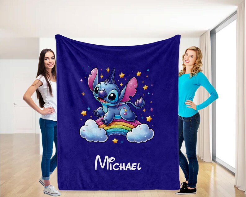 May include: A blue fleece blanket with a cartoon Stitch character riding a rainbow. The blanket has a starry background and the name "Michael" is printed on the bottom.