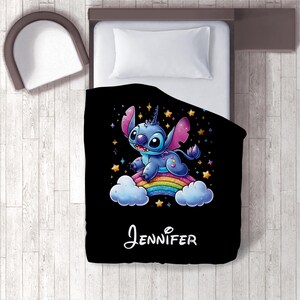May include: Black and blue Stitch character from Lilo & Stitch riding a rainbow on a cloud with stars. The text "JENNIFER" is printed below the character.