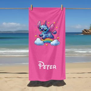 May include: Pink beach towel with a blue Stitch character riding a rainbow. The towel has the name "Peter" printed on it.