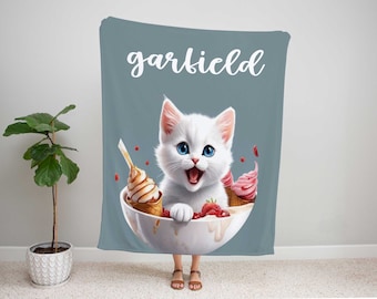 May include: A white cat with blue eyes is sitting in a bowl of ice cream and strawberries. The bowl is white with a blue rim. The cat is smiling and has a pink nose. The background is a light blue color with the word "garfield" written in white.