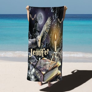 May include: A purple beach towel with a white owl flying over a castle, a lit candle, a book, and glasses. The text "Jennifer" is written on the towel.