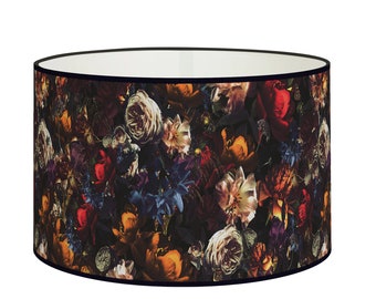 May include: A round lampshade with a black trim and a floral print featuring a variety of colorful flowers on a dark background.