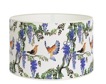 May include: White lampshade with a floral pattern featuring blue wisteria flowers and orange birds on branches.