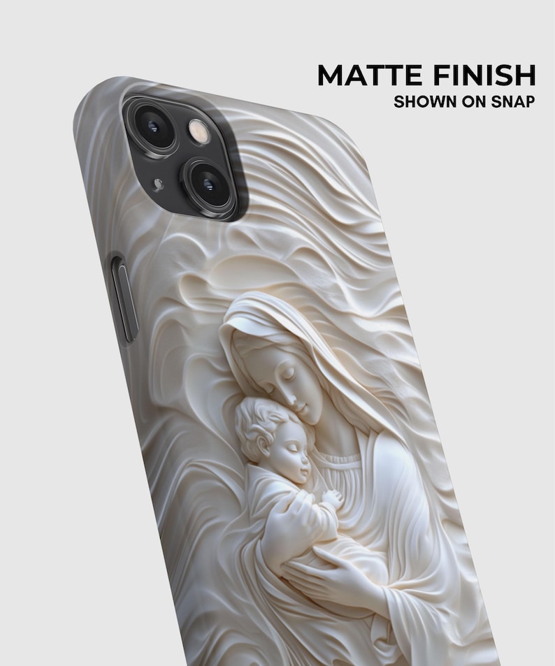 May include: A phone case with a matte finish featuring a raised, cream-colored relief sculpture of a figure holding a child, surrounded by flowing, wave-like patterns. The text MATTE FINISH SHOWN ON SNAP is printed in the upper right corner.