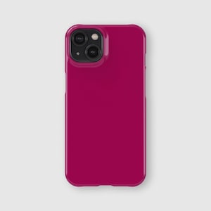 May include: A solid magenta smartphone case with a smooth, matte finish. The case features a rectangular shape with rounded corners and a raised square camera cutout in the upper left corner, designed to accommodate a dual-lens camera system.