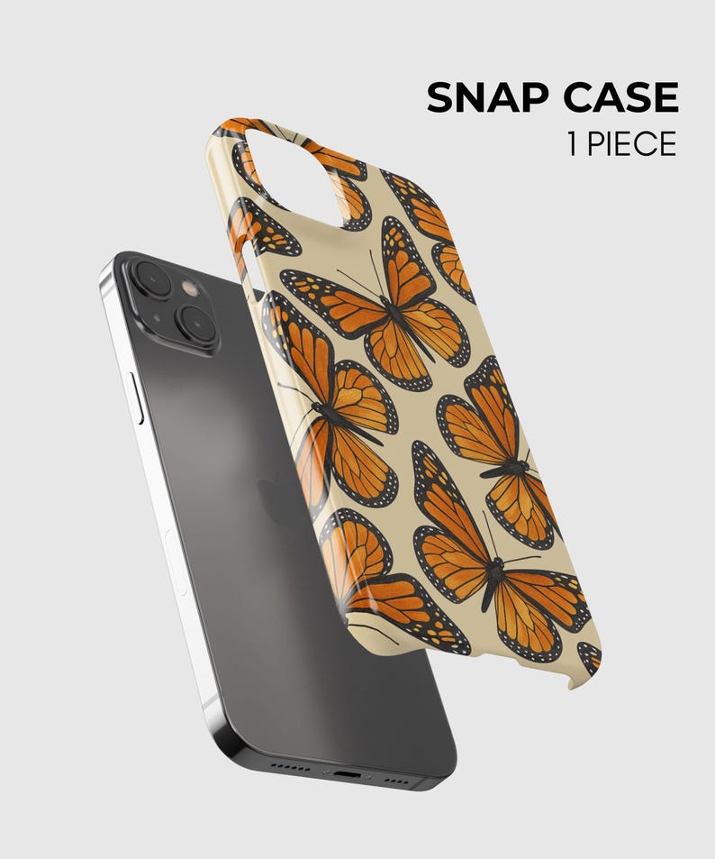 Może przedstawiać: Ciemnoszary smartfon w połączeniu z etui typu snap w kolorze kremowym, ozdobionym powtarzającym się wzorem pomarańczowo-czarnych motyli monarch&oacute;w. Tekst SNAP CASE 1 PIECE jest nadrukowany na czarno w prawym g&oacute;rnym rogu obrazu.