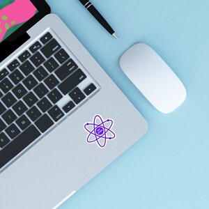 May include: A silver laptop computer with a black keyboard and a purple atom sticker on the top right corner. A white wireless mouse and a black pen are on the light blue surface.