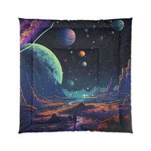 May include: A comforter featuring a vibrant, colorful space scene. The design includes planets, stars, and a landscape with a river. The color palette includes blues, purples, oranges, and greens, creating a cosmic theme.
