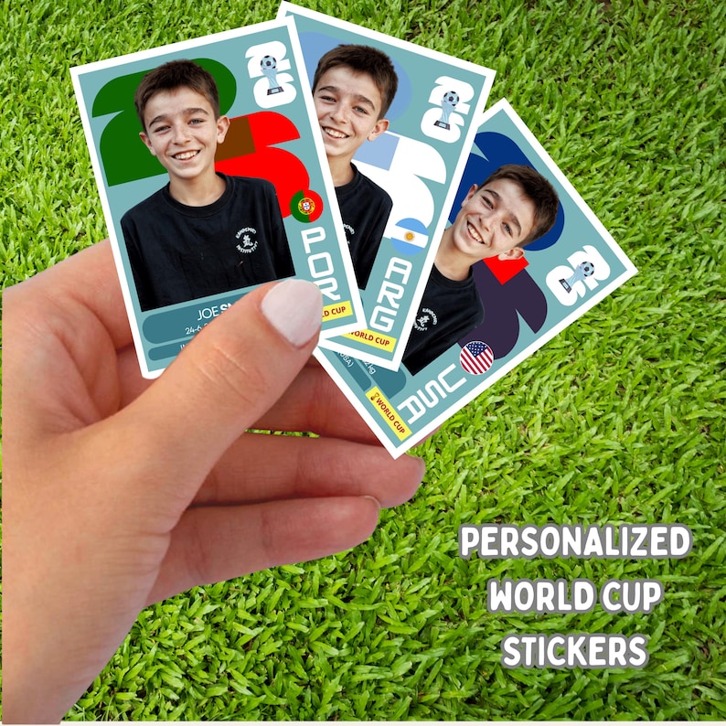 May include: Three personalized World Cup stickers featuring a smiling boy in a black shirt. Each sticker has a different flag design: Portugal, Argentina, and USA. The stickers are held against a green grass background.