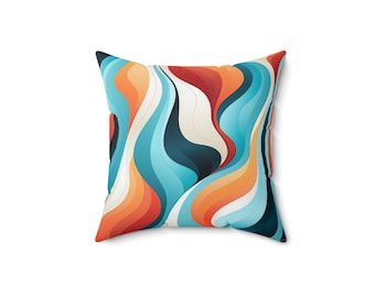 May include: Square throw pillow with a vibrant, abstract design. The pillow features a flowing pattern of orange, red, teal, and white wavy lines. The pillow is square and appears to be made of a soft fabric.