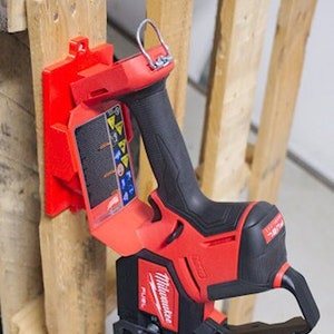 May include: A red and black Milwaukee power tool with a black blade is mounted on a wooden wall using a 3D printed wall mount.