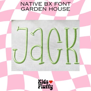 May include: Green embroidered letters spelling "JACK" in a whimsical font style on a white fabric background. The letters are outlined in a darker green thread. The image is framed by a pink and white checkered pattern.