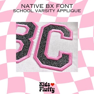 May include: Close-up of a white fabric with a black and silver glitter "BC" applique with a pink outline. The applique is a varsity style font.