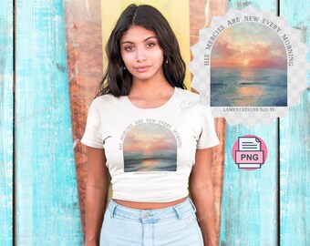 May include: A white t-shirt with a graphic design of a sunset with the text "His mercies are new every morning" and the scripture reference "Lamentations 3:22-23".
