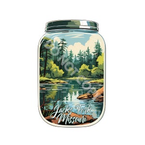 May include: A glass jar with a metal lid containing a depiction of a forest scene with a lake and the text "Jacks Fork Missouri".