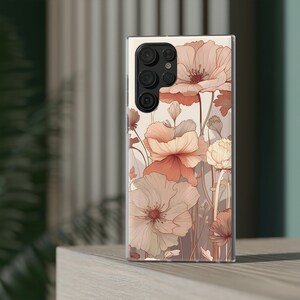 May include: A clear phone case featuring a floral design. The flowers are in shades of pink, peach, and white. The case has a cut-out for the camera lens.