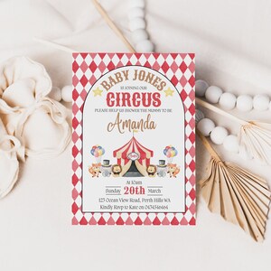 May include: A red and white circus themed baby shower invitation with a cartoon illustration of a circus tent, animals, and balloons. The text reads "Baby Jones is joining our Circus. Please help us shower the mummy to be Amanda. At 10am Sunday 20th March. 123 Ocean View Road, Perth Hills WA. Kindly Rsvp to Kate on 0434546464."