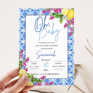 May include: A blue and white patterned baby shower invitation with a floral border and lemons. The text reads "Oh, Baby" and includes the date, time, and location of the event. RSVP information is also included.