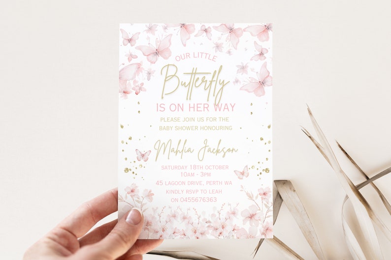 May include: Pink and gold baby shower invitation with a butterfly design. The text reads "Our Little Butterfly is on her way." The invitation includes the date, time, and location of the shower.