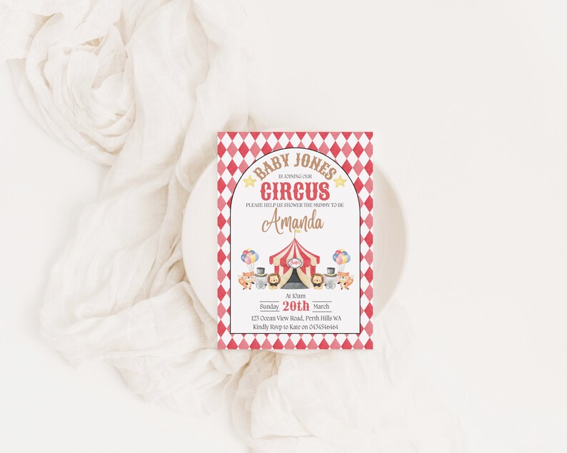 May include: A red and white checkered baby shower invitation with a circus theme. The invitation says "Baby Jones is joining our circus" and "Please help us shower the mommy to be Amanda". The invitation also includes a date, time, and location.