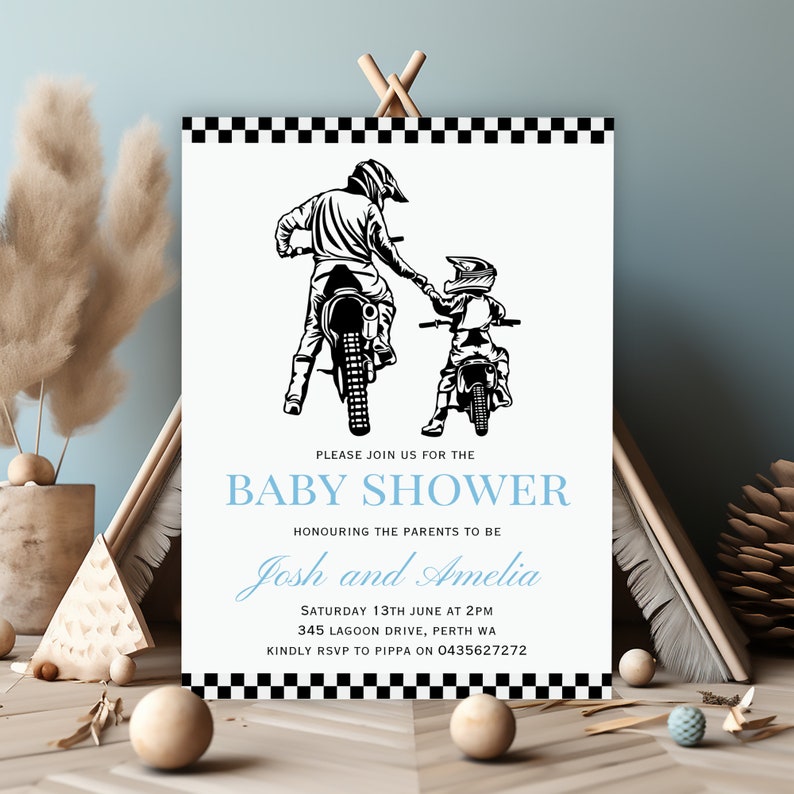May include: Black and white illustration of a father and son riding dirt bikes. The invitation reads "Please join us for the Baby Shower Honoring the parents to be Josh and Amelia Saturday 13th June at 2PM 345 Lagoon Drive, Perth WA Kindly RSVP to Pippa on 0435627272"