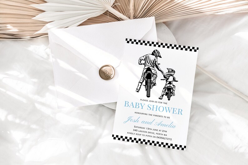 May include: A black and white baby shower invitation with a checkered border. The invitation features a drawing of two people riding dirt bikes. The text on the invitation reads "Please join us for the Baby Shower honoring the parents to be Josh and Amelia. Saturday 13th June at 2pm. 345 Lagoon Drive, Perth WA. Kindly RSVP to Pippa on 0435627272."