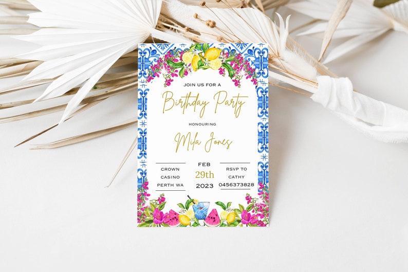May include: A white invitation with blue and white tile border and floral accents. The invitation is for a birthday party for Mila Jones at Crown Casino in Perth, WA on February 29th, 2023. RSVP to Cathy at 0456373828.