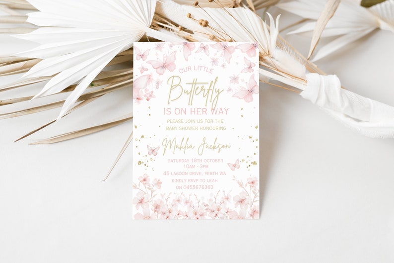 May include: A pink and gold baby shower invitation with a butterfly design. The text reads "Our Little Butterfly Is On Her Way" and includes the date, time, and location of the event.