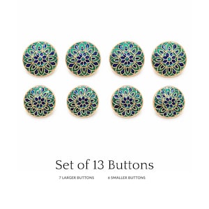 May include: A set of 13 buttons featuring a circular design with gold-toned edges and a floral pattern in shades of blue and green enamel. The text Set of 13 Buttons, 7 Larger Buttons, and 6 Smaller Buttons is printed below the buttons.