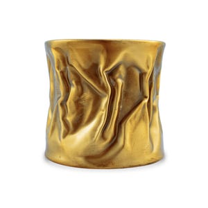 May include: A gold-colored, cylindrical decorative vase with a textured, crumpled appearance. The vase has a smooth, rounded base and a slightly wider top. The surface of the vase has a rippled, fabric-like texture.