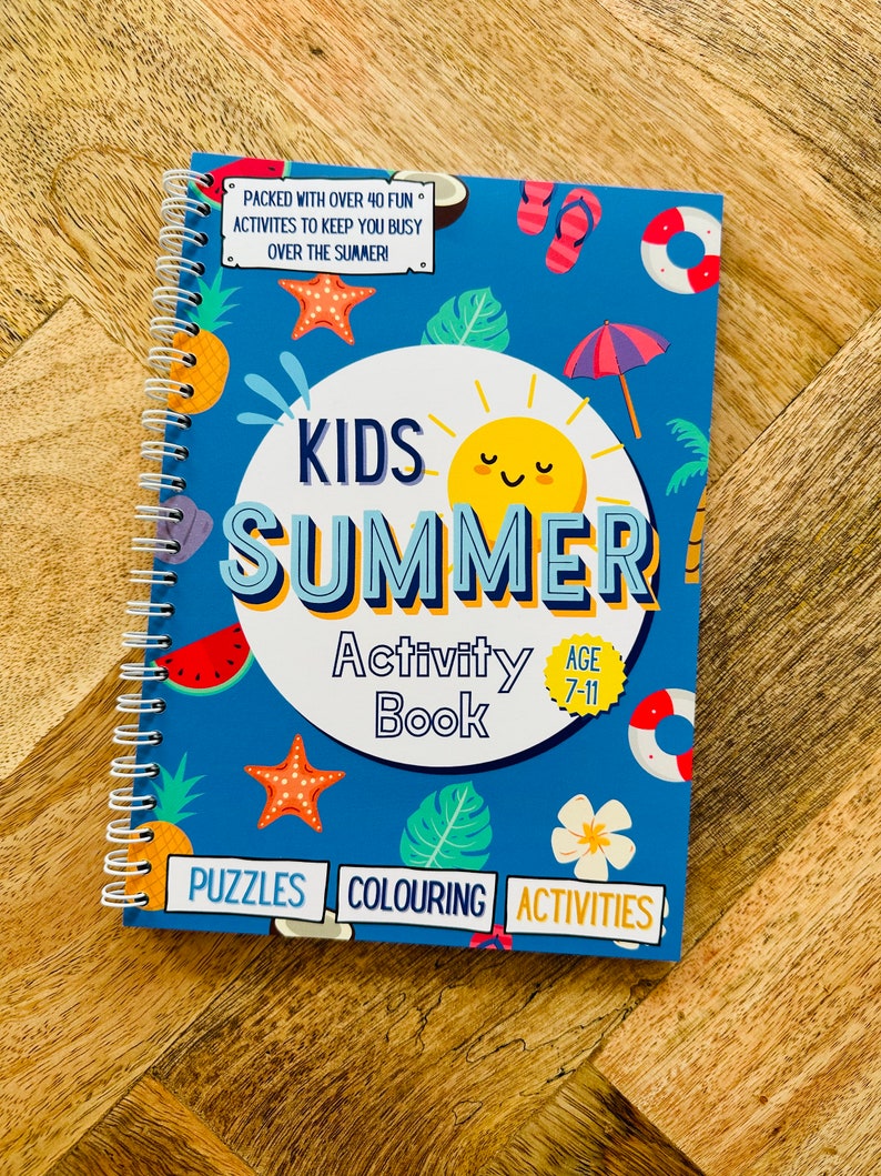 May include: A blue and yellow activity book for kids with a summer theme. The cover features a sun, a watermelon, a pineapple, a starfish, a palm leaf, and a flower. The title is "Kids Summer Activity Book" and the age range is 7-11. The book includes puzzles, coloring, and activities.
