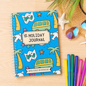 May include: A spiral-bound travel journal with a blue cover. The cover design includes illustrations of a bus, palm trees, maps, and airplanes. The journal is titled "My Holiday Journal" and has the text "Never Forget an Adventure!"