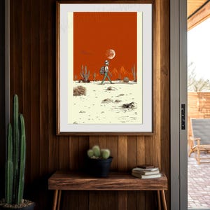 The artwork styled above a rustic wood bench surrounded by tall cactus plants and woven baskets, creating a natural southwestern entryway display.