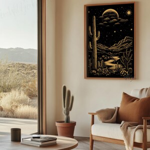The framed print hanging in a cozy seating area beside a large window overlooking the desert landscape, styled with a warm-toned chair and minimal decor.
