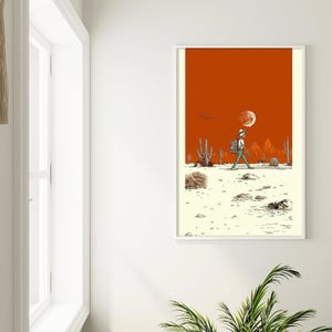 The poster hung in a bright hallway nook with white walls and a desert plant, styled for a minimalist home or dorm.