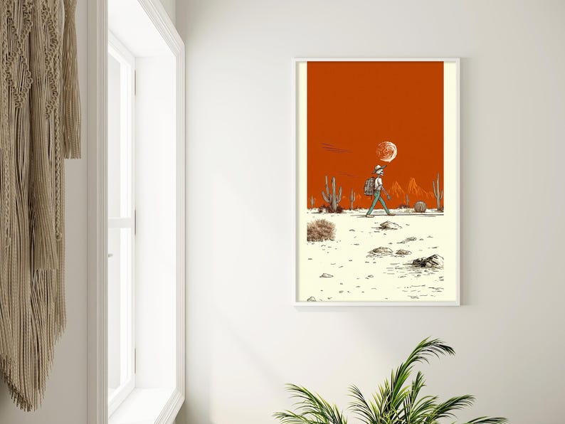 The poster hung in a bright hallway nook with white walls and a desert plant, styled for a minimalist home or dorm.