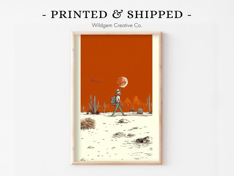 Unframed print held in cozy sweater-clad hands atop a soft fabric surface, styled as a giftable, ready-to-frame piece of art.