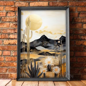 May include: A framed print of a desert landscape with a golden sun, black mountains, and cacti. The print features a watercolor style with gold accents and white flowers.