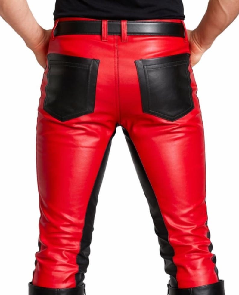 May include: Red leather pants with black accents. The pants feature black pockets and black panels down the sides. A black belt is visible at the waist.