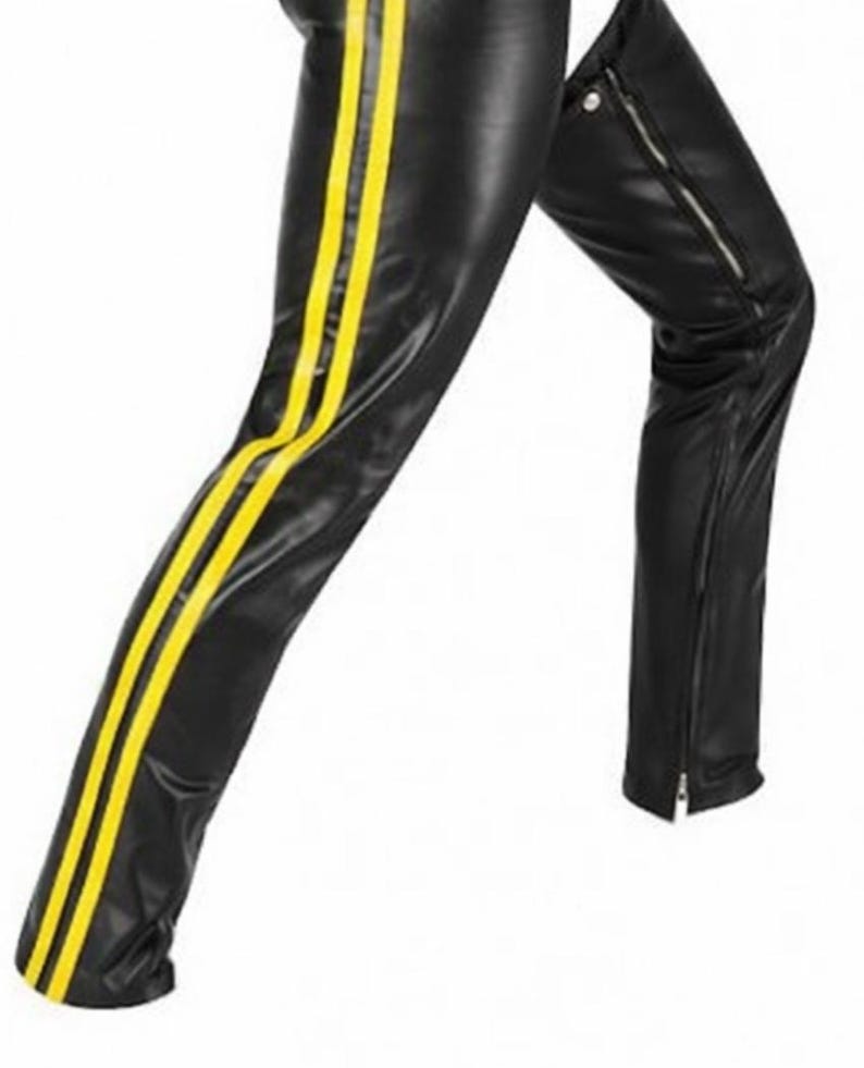 May include: Black leather pants with two vertical yellow stripes down the side of the leg. The pants have a zipper detail on the lower leg. The material appears to be shiny.
