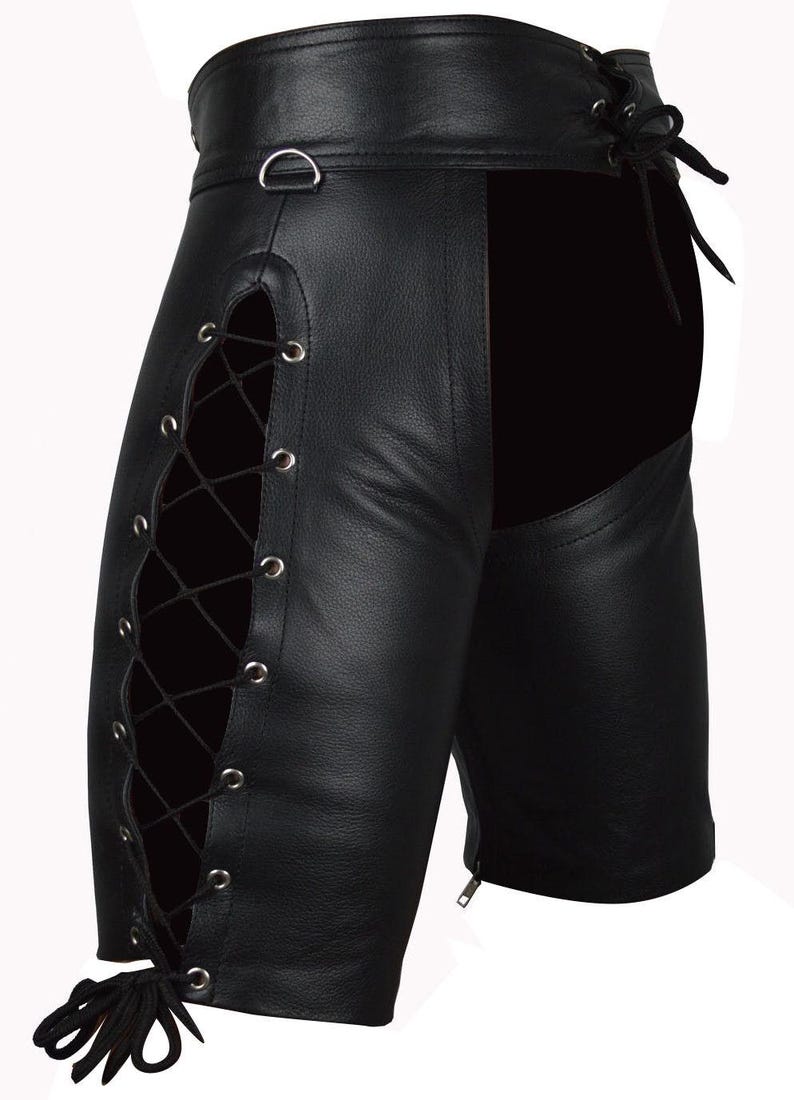 May include: Black leather shorts with lace-up detailing on the sides. The shorts feature a high waist, a D-ring, and a zipper closure. The design includes a solid black panel on the back.