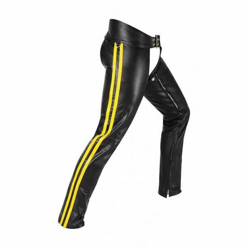 May include: Black leather chaps with two vertical yellow stripes on the left leg. The chaps have a belt with a silver buckle and a zipper on the right leg. The chaps are designed to be worn over other pants.