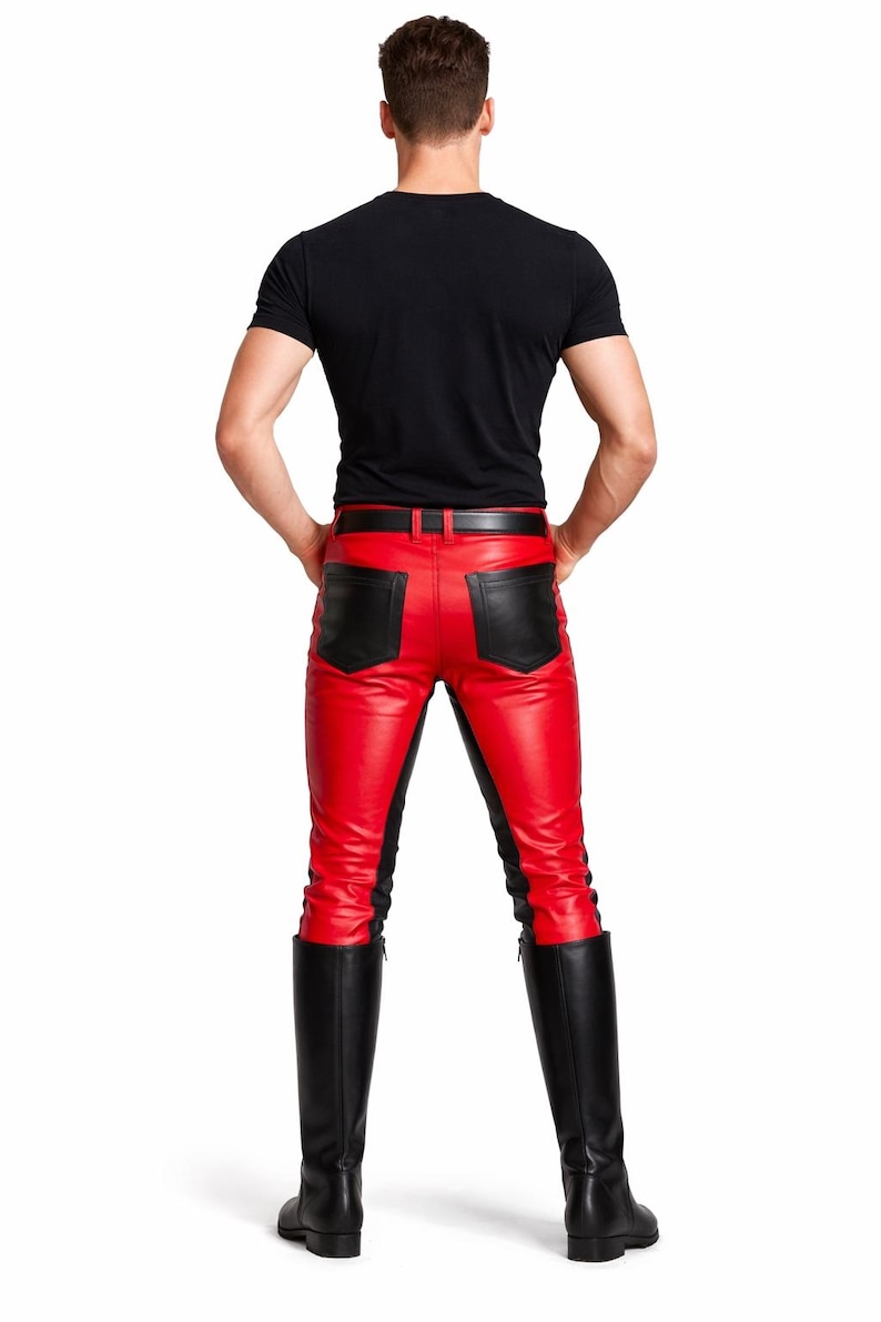 May include: Red leather pants with black accents and a black belt. The pants have black panels on the sides and back pockets. The person is also wearing a black t-shirt and black knee-high boots.